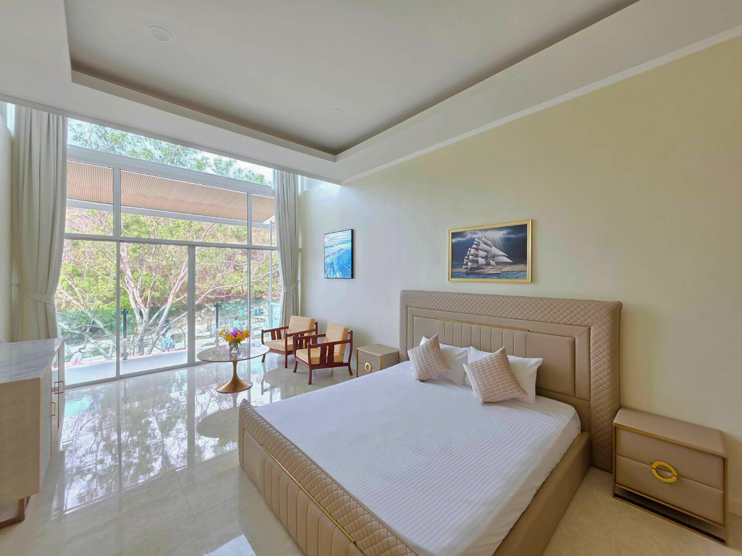 Comfortable bed with tropical garden and sea view from the Tropical Escape Room at Ta Yai Beach Resort, Koh Larn